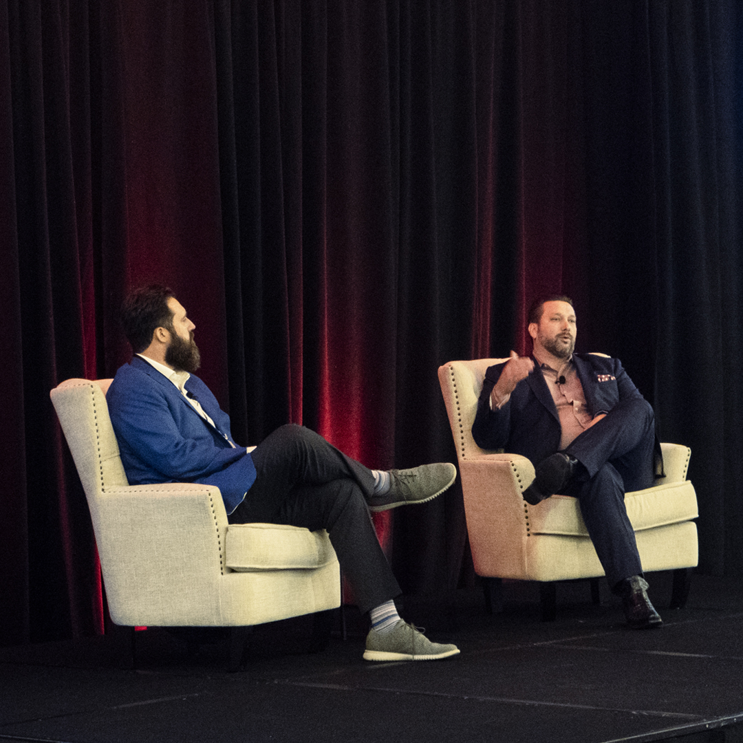 Jay J.P. Peak speaking on stage at an insurance agent coaching event.